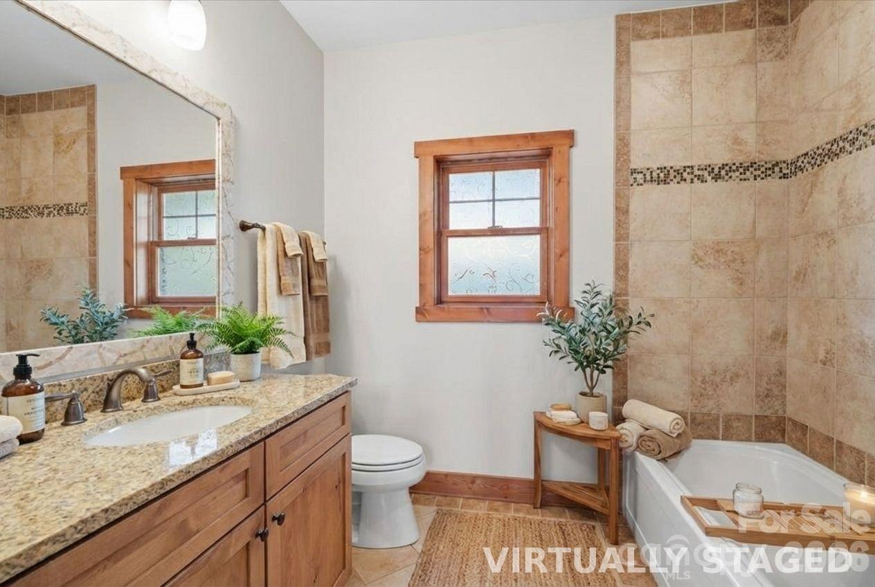 13 Miners Trace Road Burnsville, NC 28714 - Photo 23 of 34 a bathroom with a granite countertop sink mirror vanity and toilet