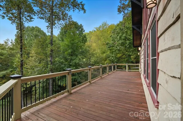 a view of a balcony with wooden floor and fence