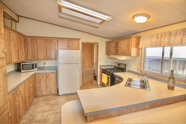 a kitchen with a stove a sink and a microwave