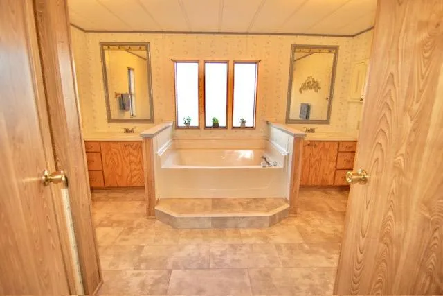 a bathroom with a bathtub and next to a window