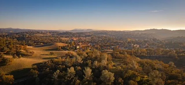 an aerial view of residential houses with outdoor space and street view