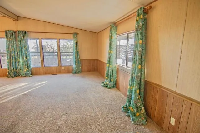 a spacious bedroom with a large bed and a chandelier