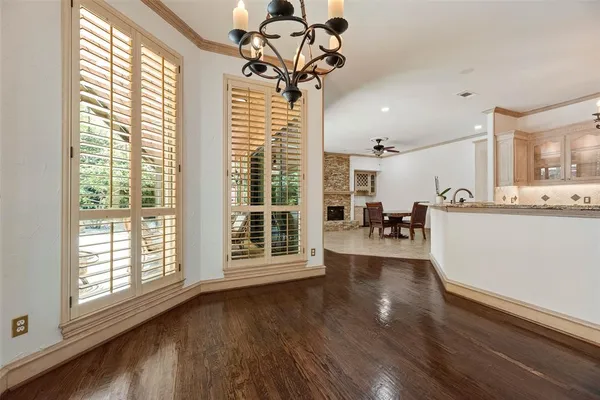 a view of a livingroom with furniture wooden floor and windows