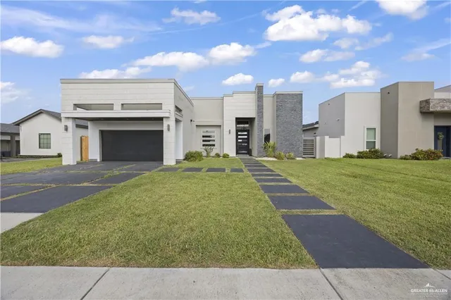 a view of an house with backyard and a tree