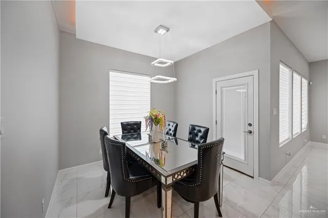 a view of a dining room with furniture and window