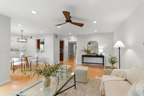 a living room with furniture and a chandelier