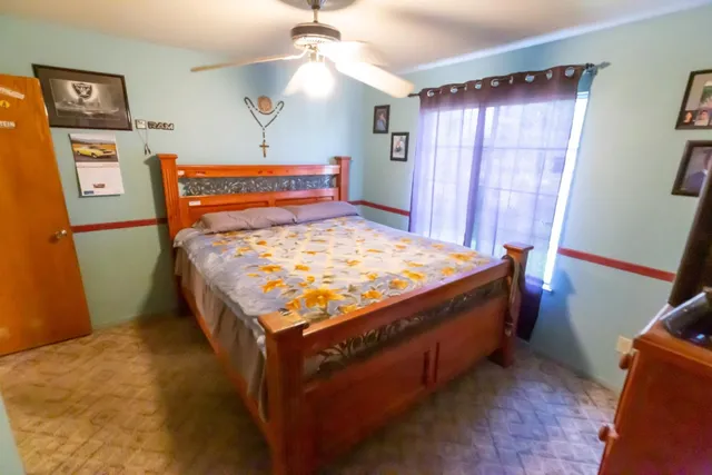 a bed sitting in a bedroom next to a window