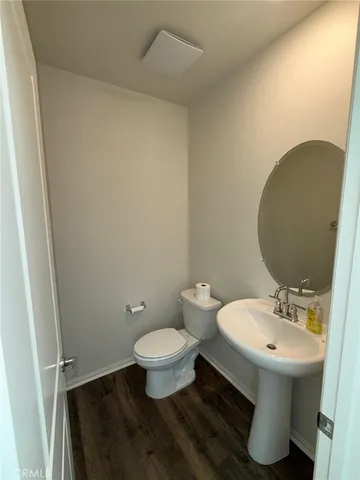 a bathroom with a sink toilet and a mirror