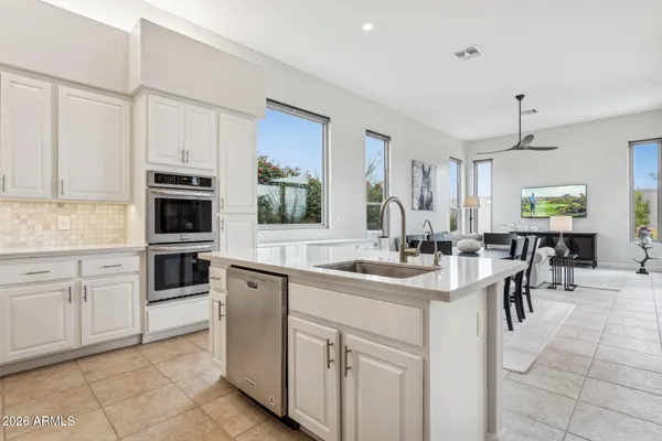 a kitchen with appliances cabinets and furniture