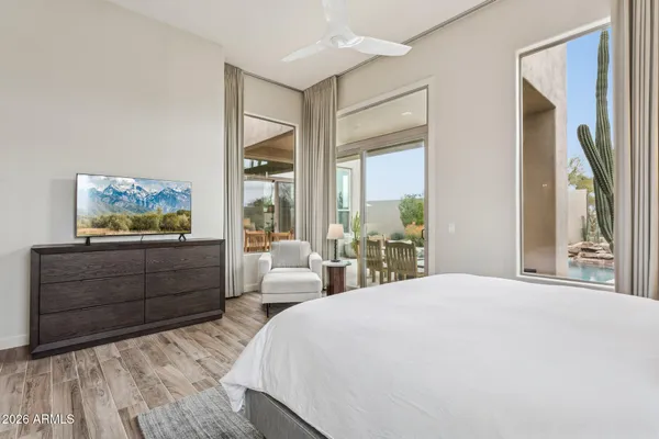 a spacious bedroom with a bed and a dresser