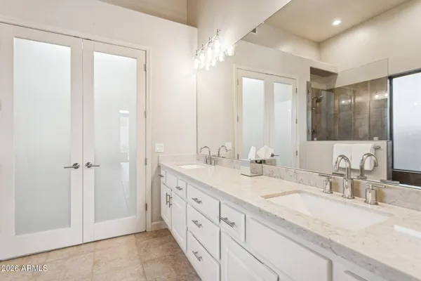 a bathroom with double sink and a mirror
