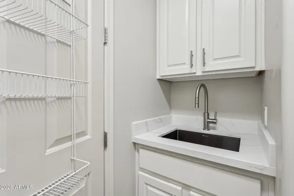 a view of a storage & utility room with two washing machine