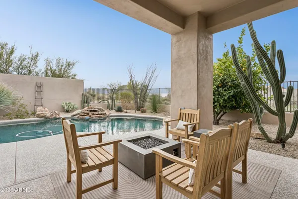 a view of a patio with table and chairs and potted plants