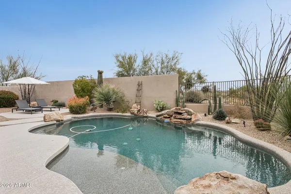 a view of swimming pool with outdoor seating and plants