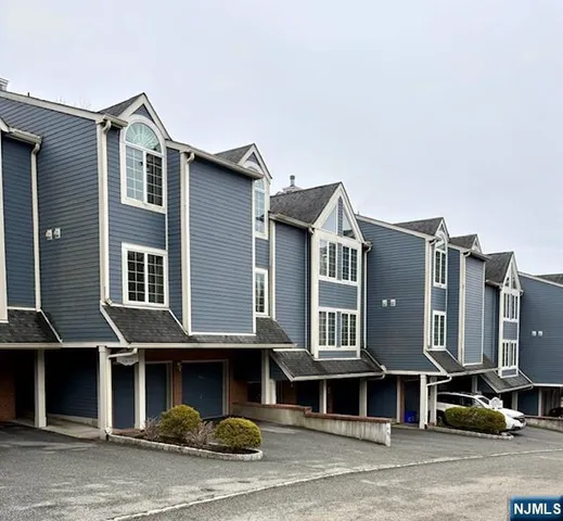 a front view of a house with a street