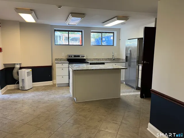 a kitchen with stainless steel appliances granite countertop a refrigerator and a stove