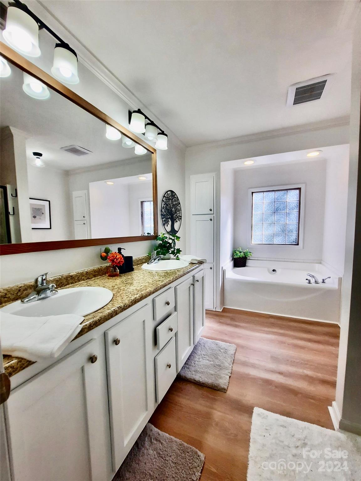 252 Souther Road Fletcher, NC 28732 - Photo 17 of 29 a spacious bathroom with a double vanity sink and a large mirror
