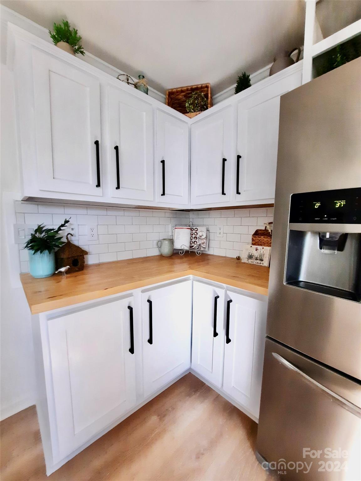 252 Souther Road Fletcher, NC 28732 - Photo 7 of 29 a kitchen with granite countertop white cabinets and white appliances