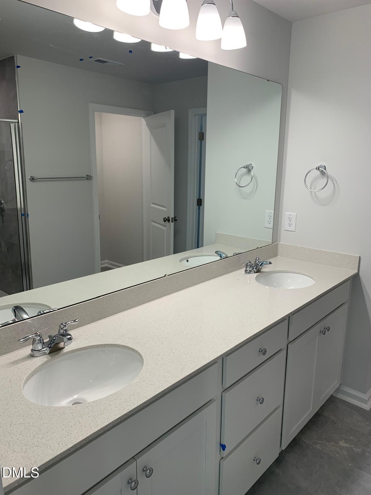 233 Broomside Avenue Raleigh, NC 27603 - Photo 16 of 18 a bathroom with a sink double vanity and a mirror