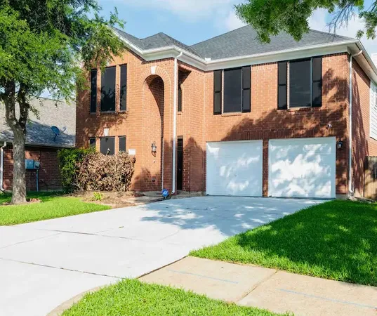 a front view of a house with a yard and a garage