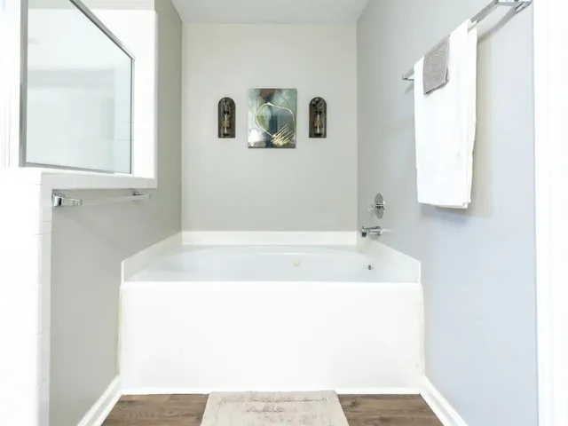 a bath tub sitting next to a white sink