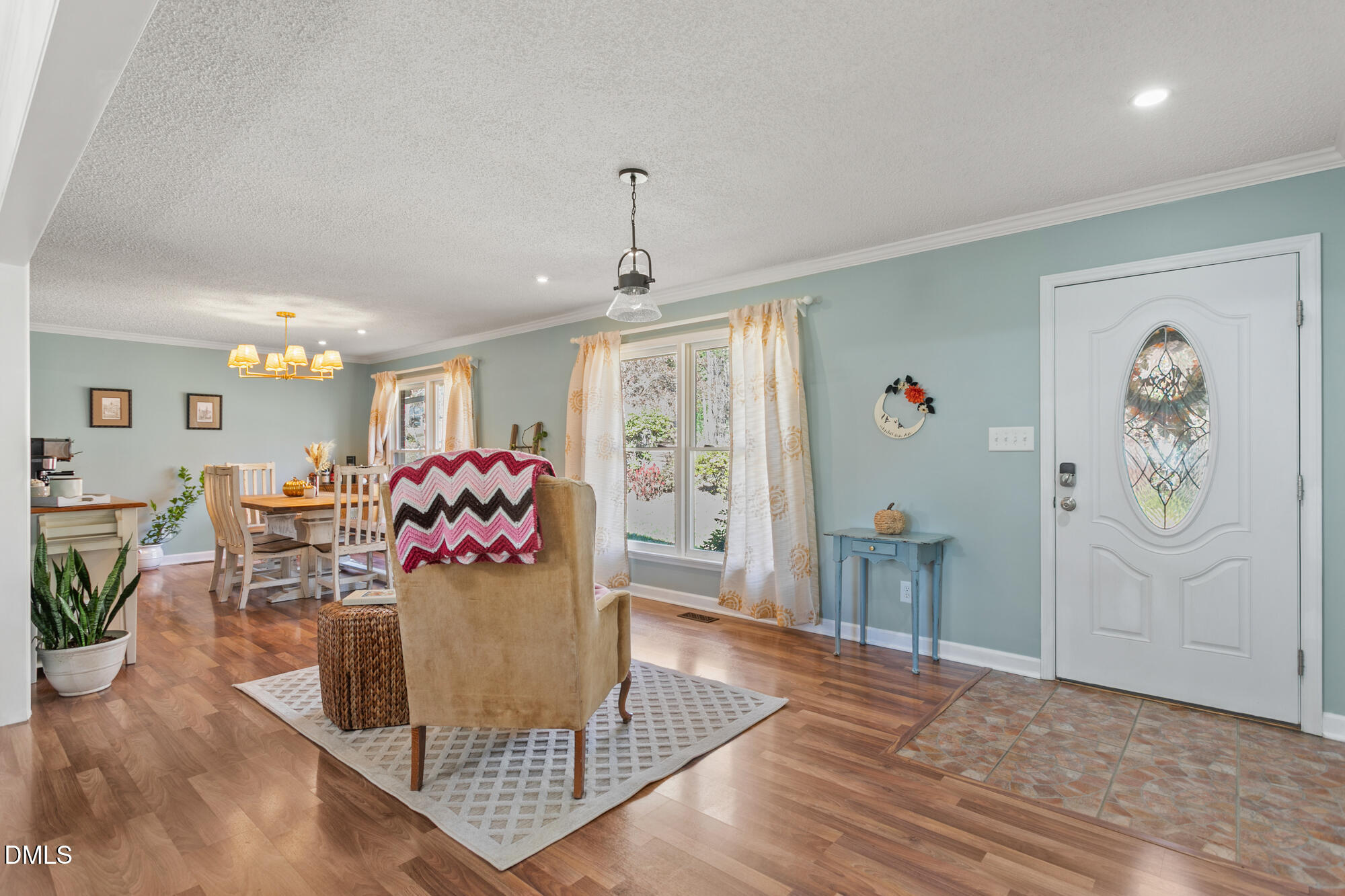 1263 Geneva Albright Road Graham, NC 27253 - Photo 14 of 61 a view of a dining room with furniture and a chandelier