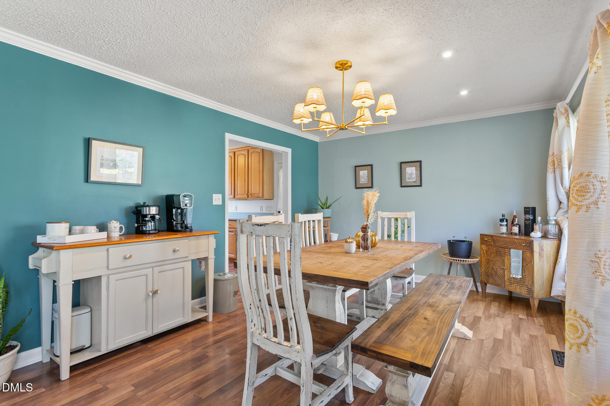 1263 Geneva Albright Road Graham, NC 27253 - Photo 17 of 61 a view of a dining room with furniture a chandelier and wooden floor
