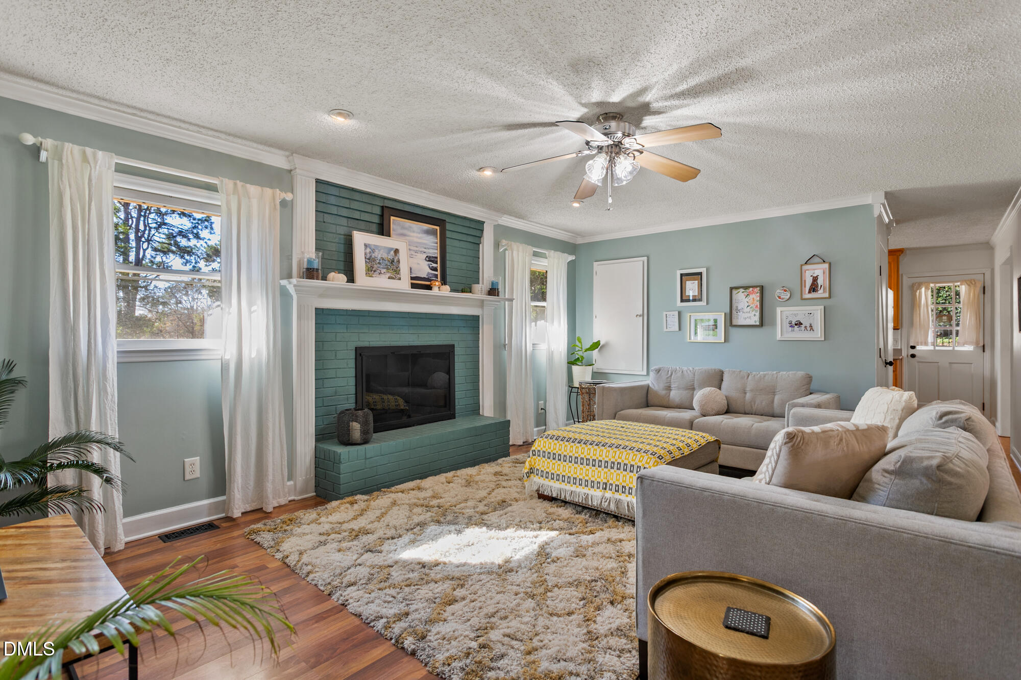 1263 Geneva Albright Road Graham, NC 27253 - Photo 24 of 61 a living room with furniture a flat screen tv and a fireplace