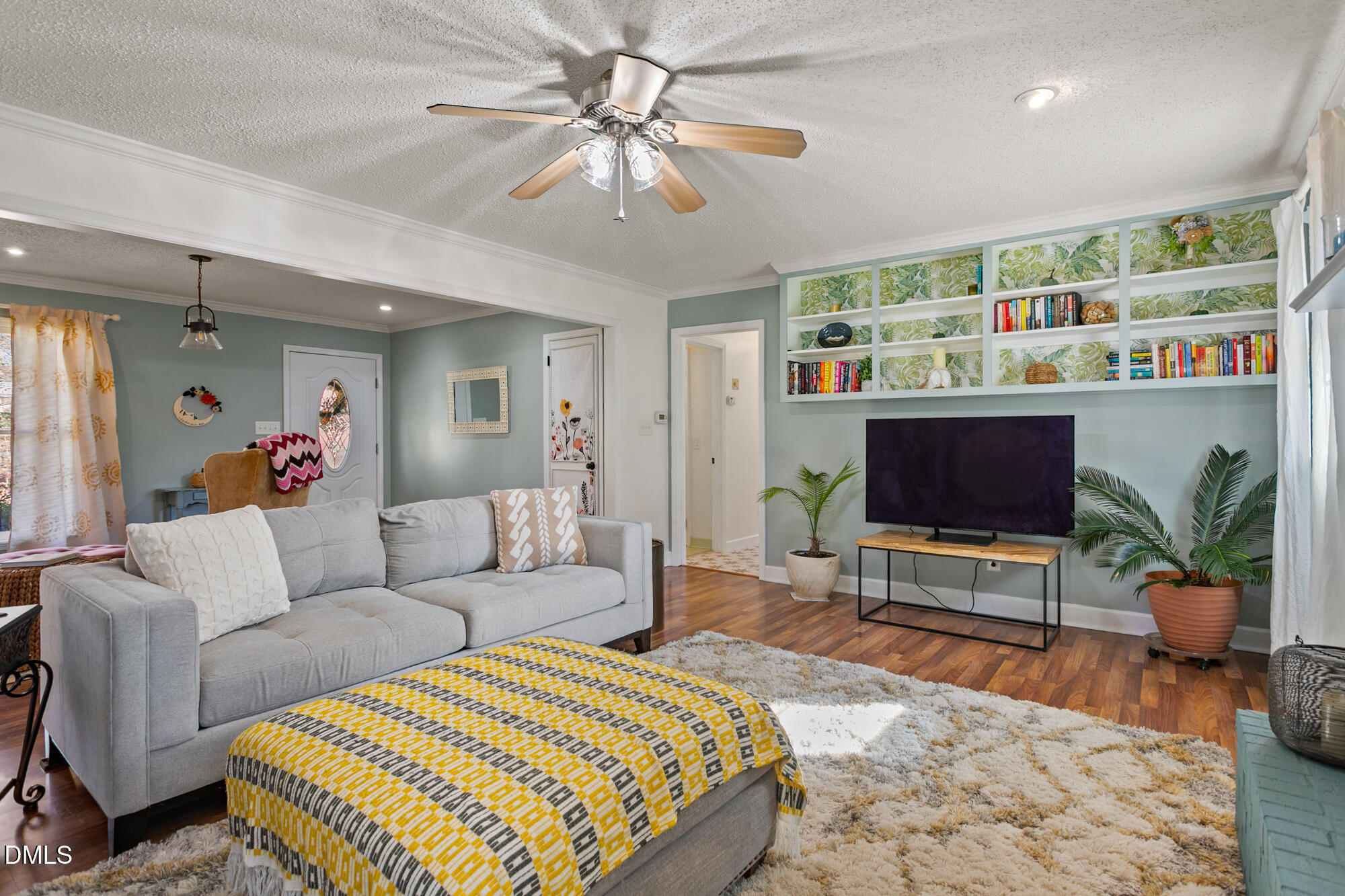 1263 Geneva Albright Road Graham, NC 27253 - Photo 25 of 61 a living room with furniture a flat screen tv and a bookshelf