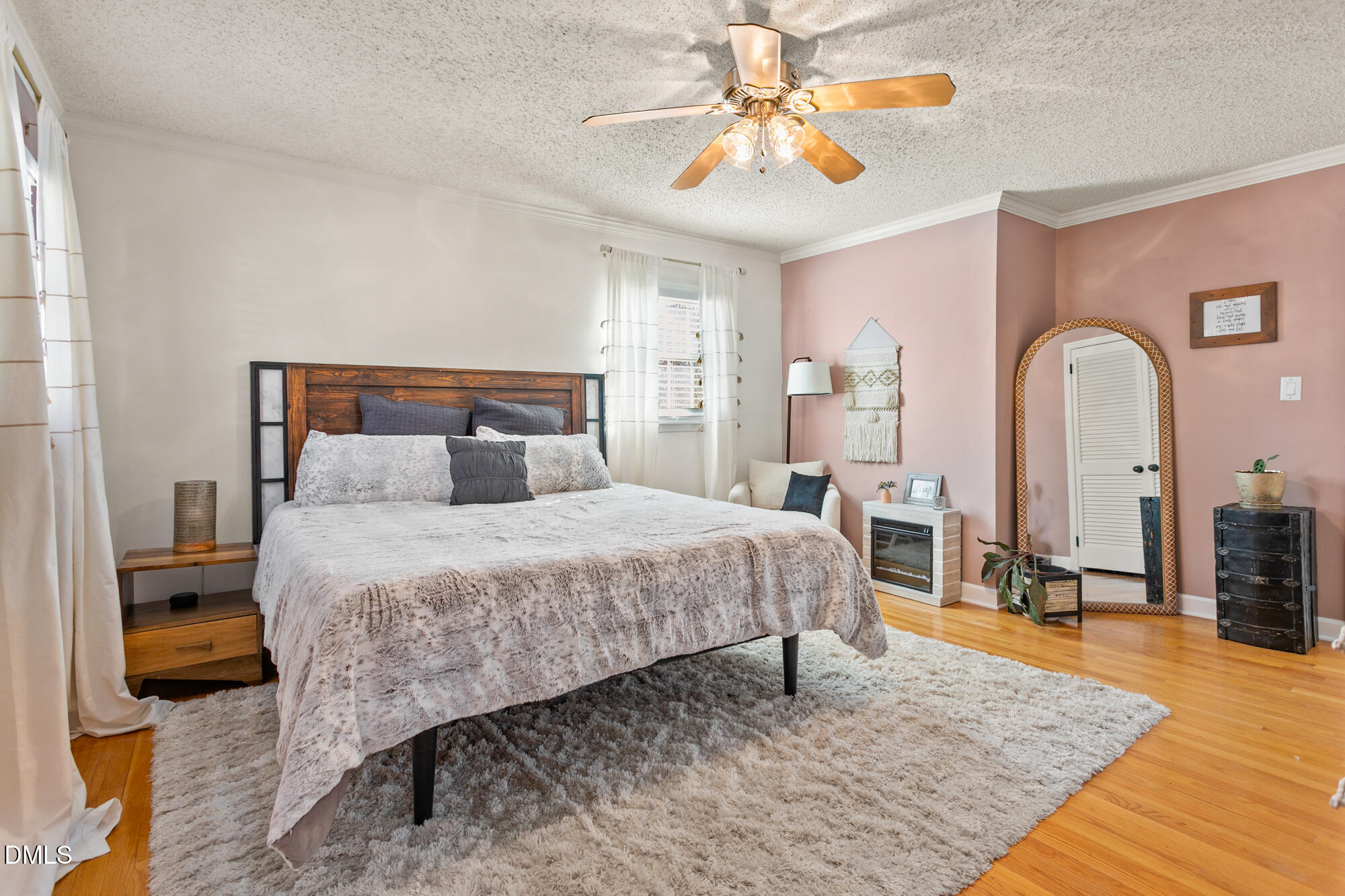 1263 Geneva Albright Road Graham, NC 27253 - Photo 33 of 61 a bedroom with a large bed a chandelier and dresser