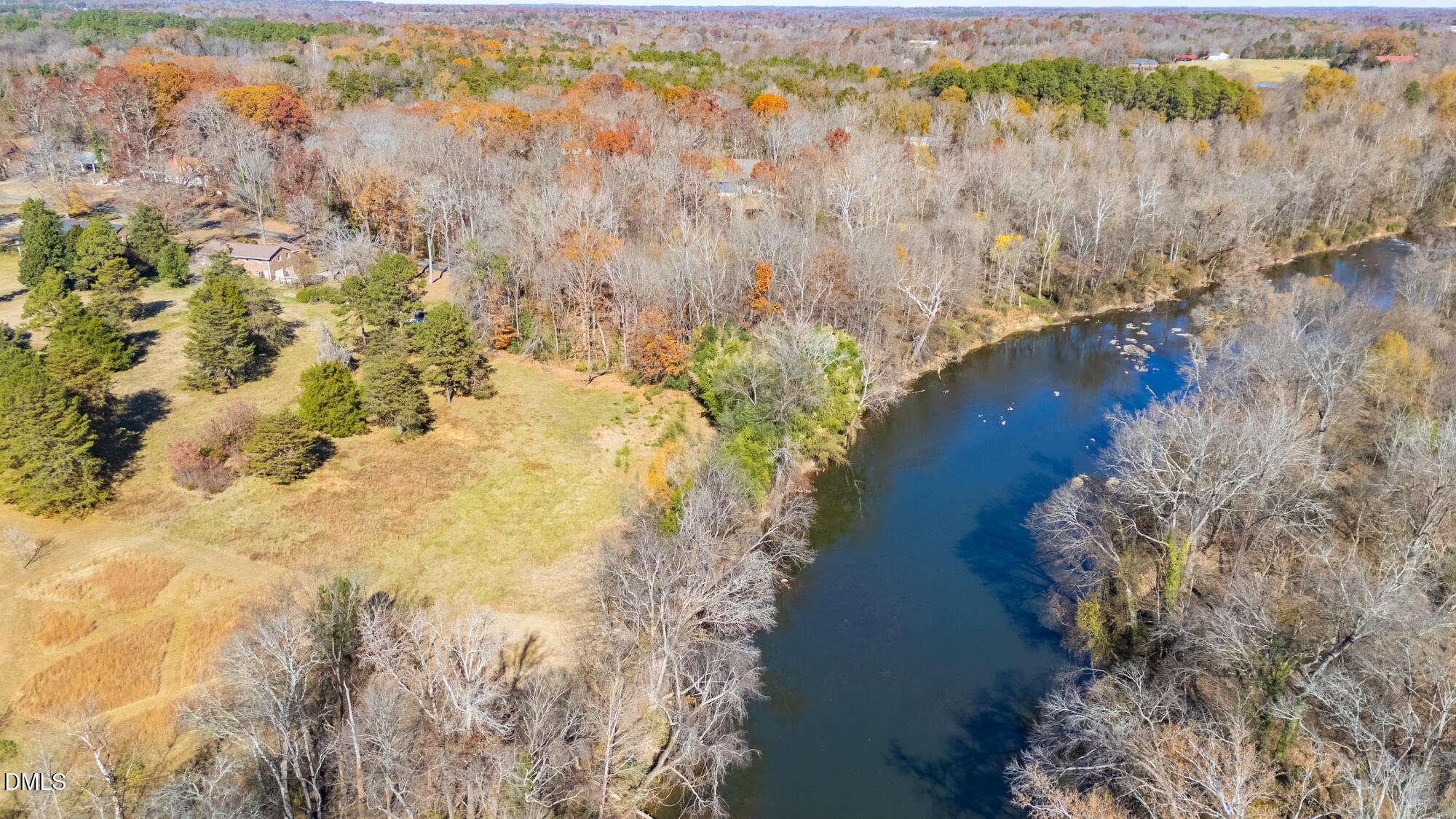 1263 Geneva Albright Road Graham, NC 27253 - Photo 56 of 61 a view of a lake with a yard and trees all around