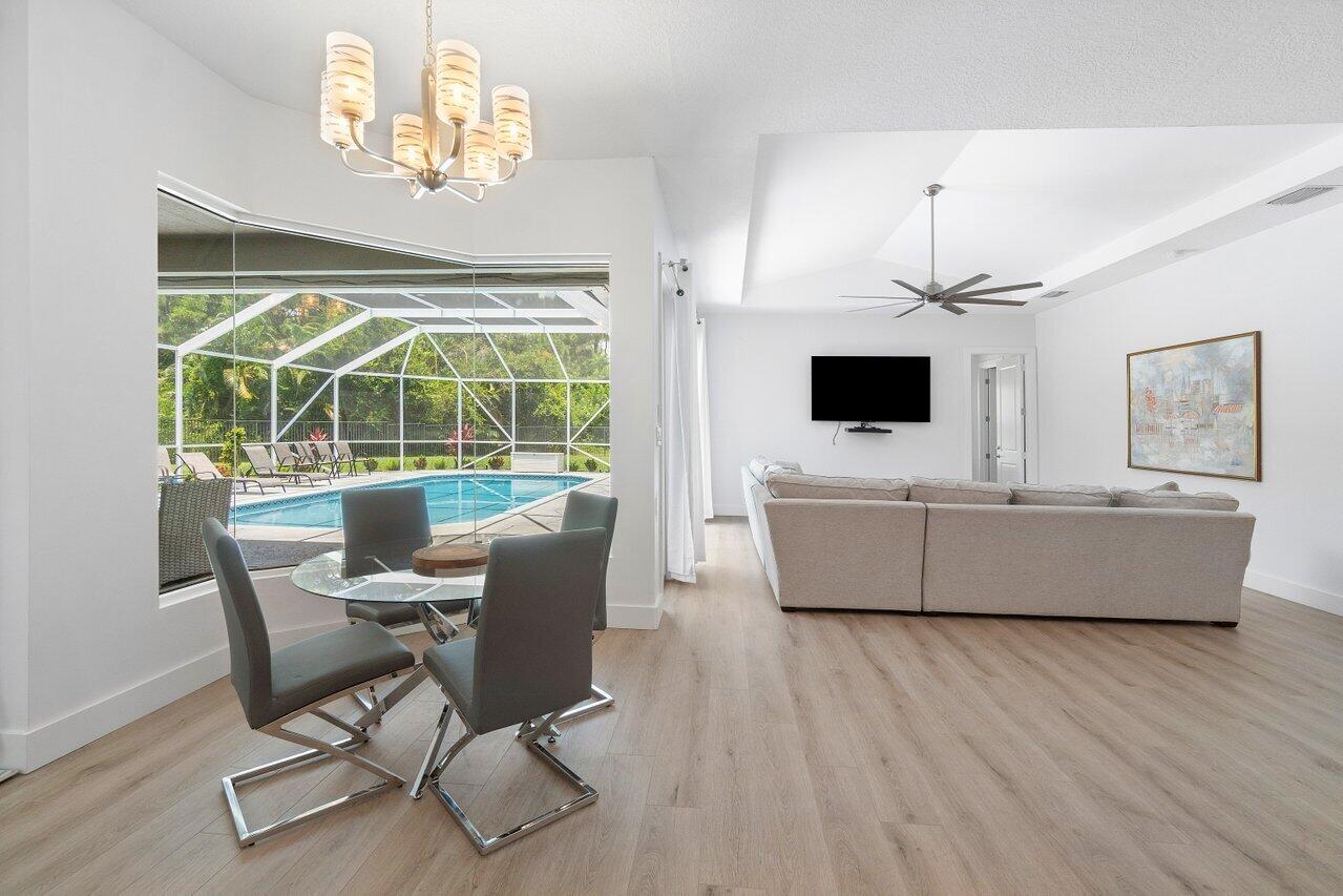 8369 Southeast Island Way Jupiter, FL 33458 - Photo 12 of 41 a living room with furniture and a flat screen tv