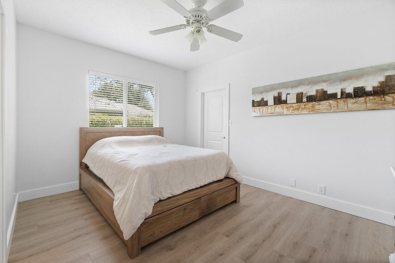 8369 Southeast Island Way Jupiter, FL 33458 - Photo 22 of 41 a bedroom with a bed and window