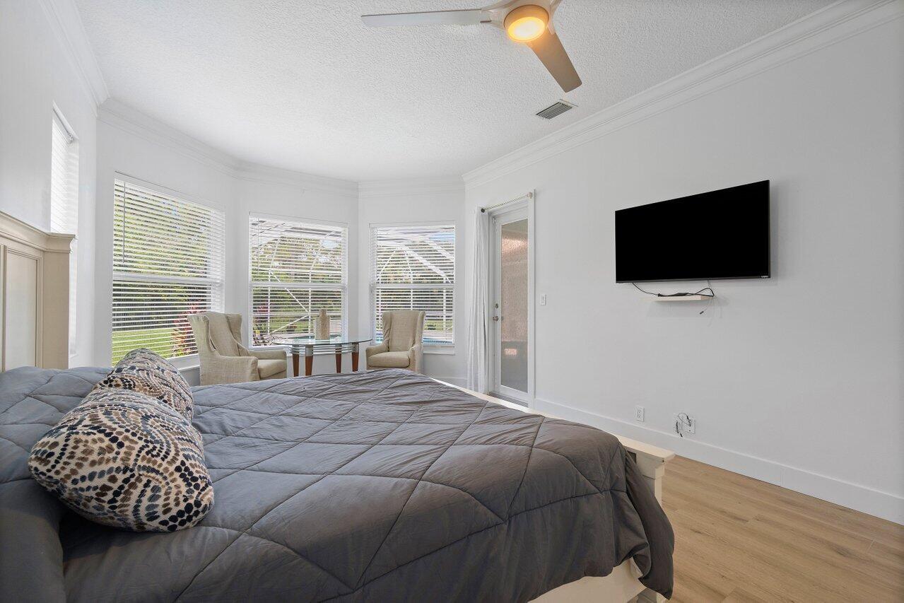 8369 Southeast Island Way Jupiter, FL 33458 - Photo 28 of 41 a bedroom with a bed and a flat screen tv