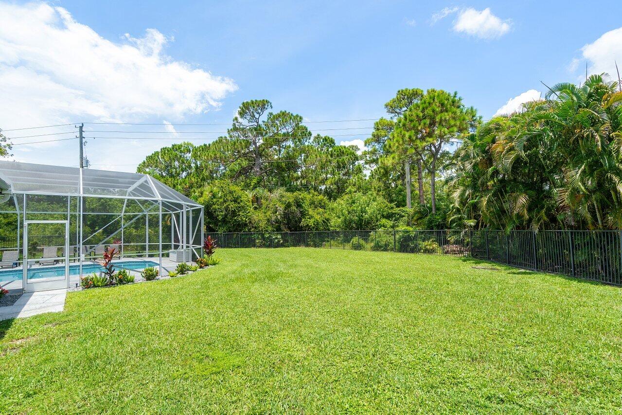 8369 Southeast Island Way Jupiter, FL 33458 - Photo 41 of 41 a view of a backyard with a garden and trees