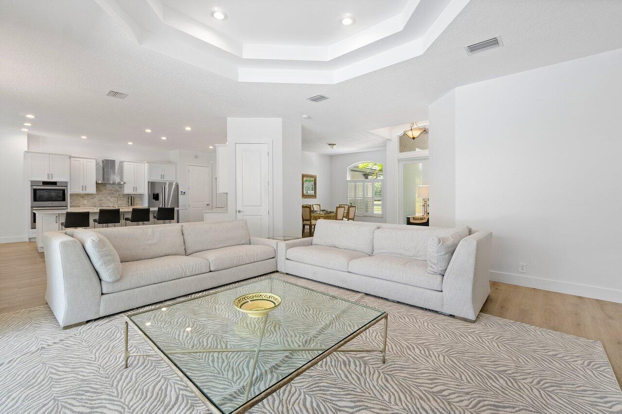 8369 Southeast Island Way Jupiter, FL 33458 - Photo 7 of 41 a living room with furniture white wall and a painting