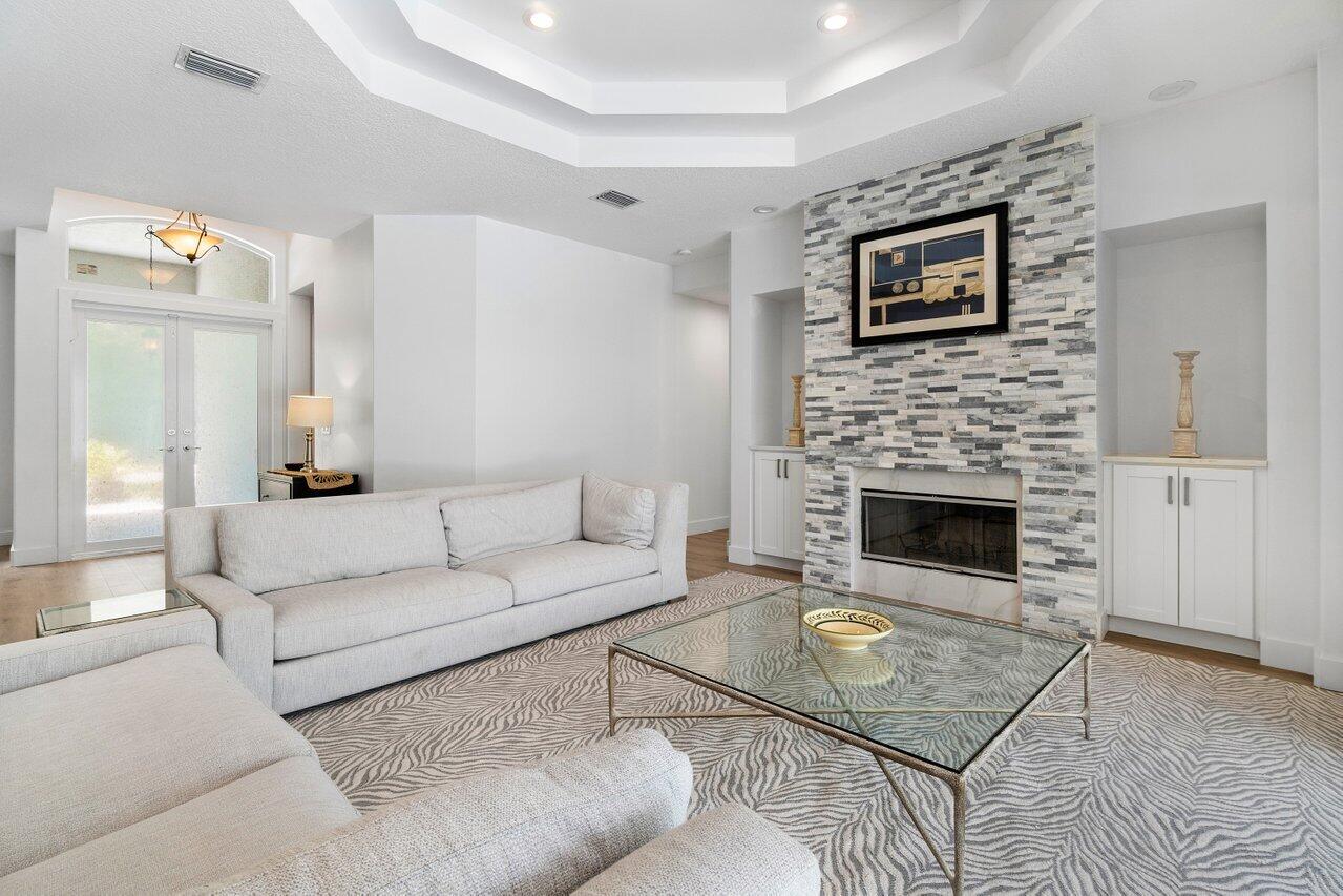 8369 Southeast Island Way Jupiter, FL 33458 - Photo 8 of 41 a living room with furniture and a fireplace