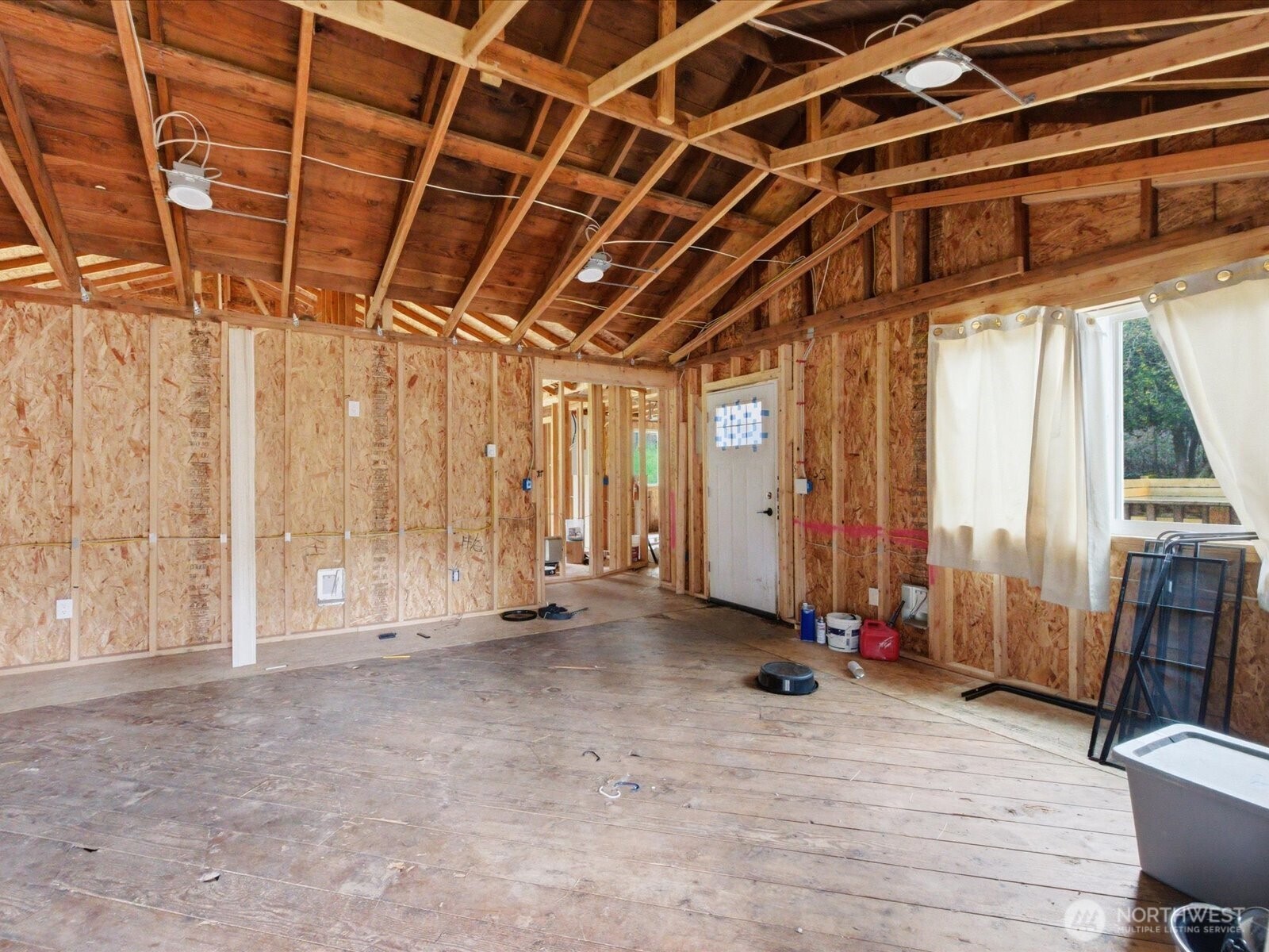 16602-16608 Delano Road Southwest Lakebay, WA 98349 - Photo 13 of 40 a view of an empty room with wooden floor and fence