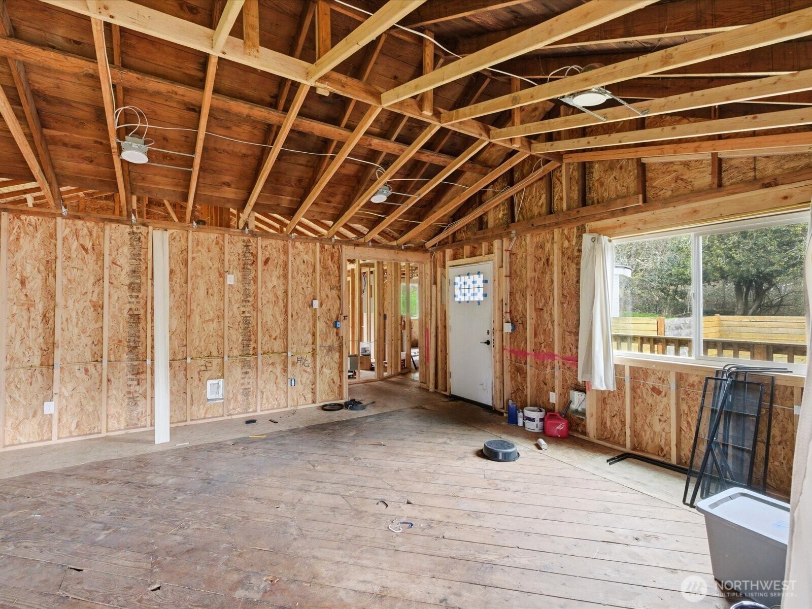 16602-16608 Delano Road Southwest Lakebay, WA 98349 - Photo 19 of 40 a view of an empty room with wooden floor and windows