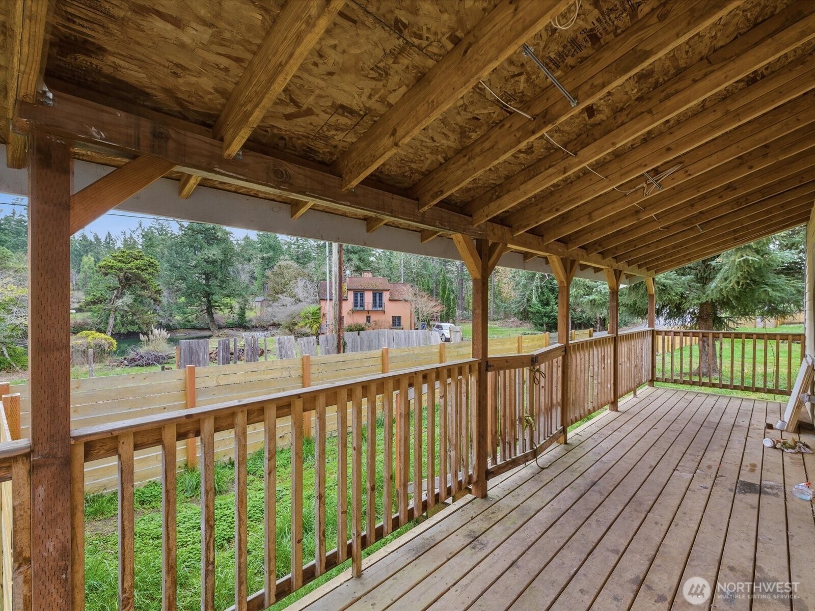 16602-16608 Delano Road Southwest Lakebay, WA 98349 - Photo 20 of 40 a view of a balcony with wooden floor