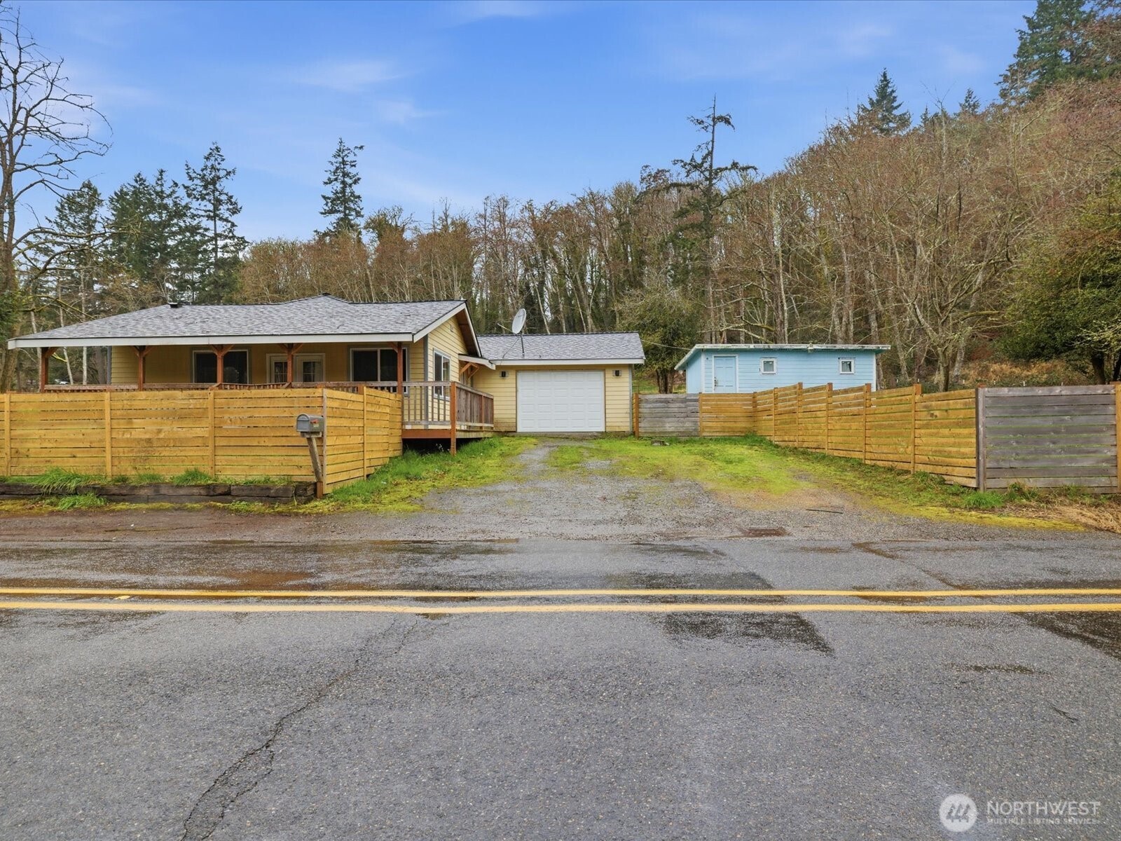 16602-16608 Delano Road Southwest Lakebay, WA 98349 - Photo 2 of 40 a view of a swimming pool with trees in the background