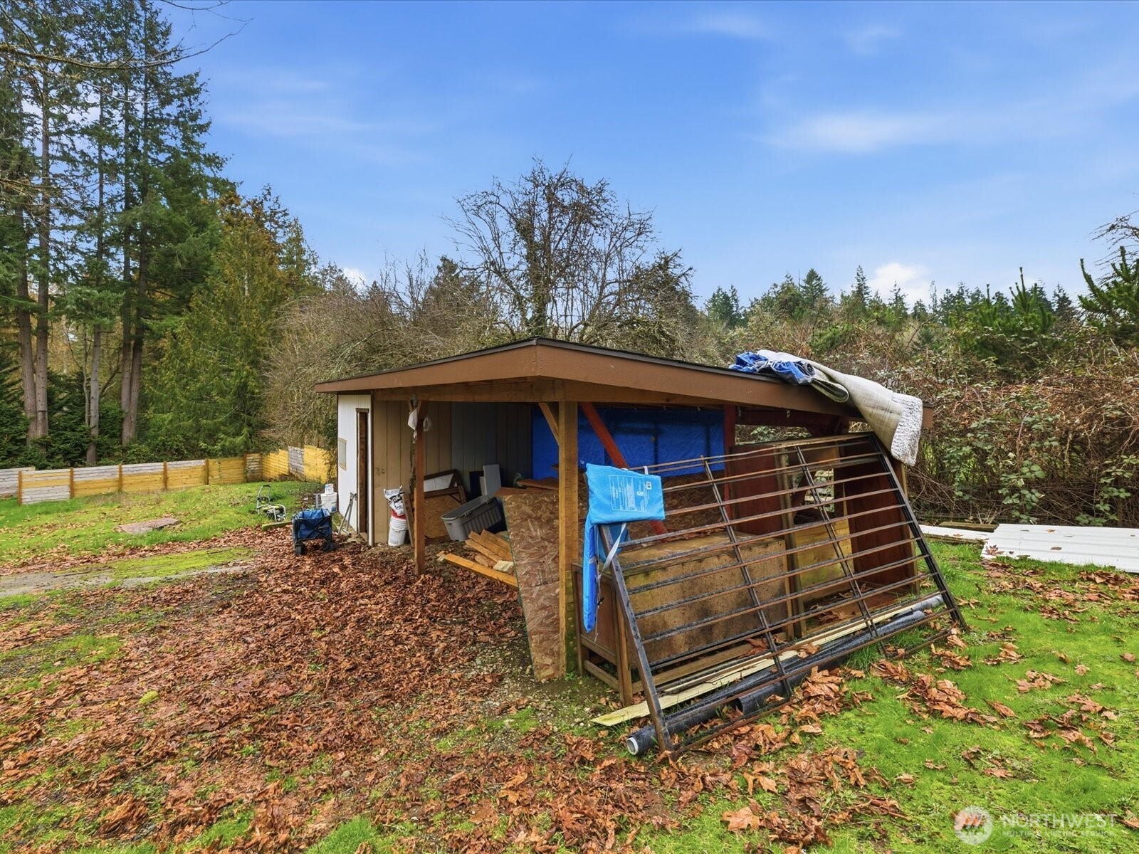 16602-16608 Delano Road Southwest Lakebay, WA 98349 - Photo 27 of 40 a view of a small house in the middle of a yard
