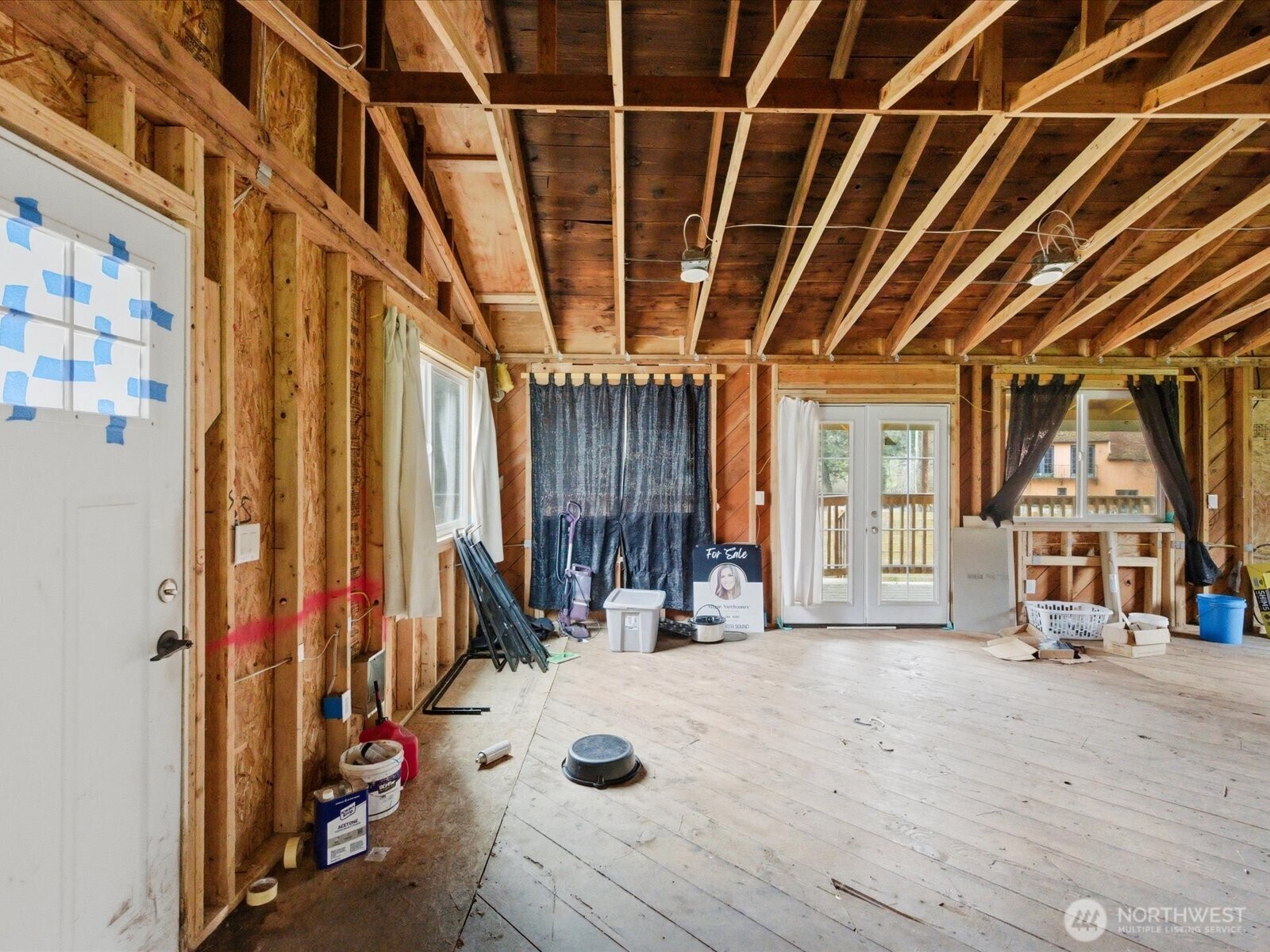 16602-16608 Delano Road Southwest Lakebay, WA 98349 - Photo 10 of 40 a view of a porch with wooden floor and windows