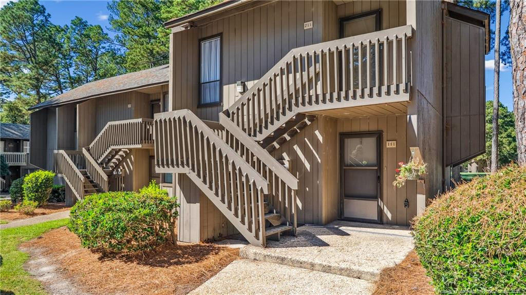 115 Beulah Hill Road South, Unit 111 Pinehurst, NC 28374 - Photo 2 of 32 a view of balcony with small garden and deck