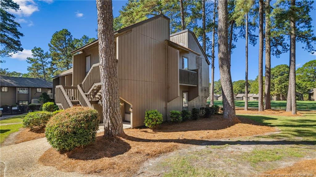 115 Beulah Hill Road South, Unit 111 Pinehurst, NC 28374 - Photo 3 of 32 a view of a house with a yard and pathway