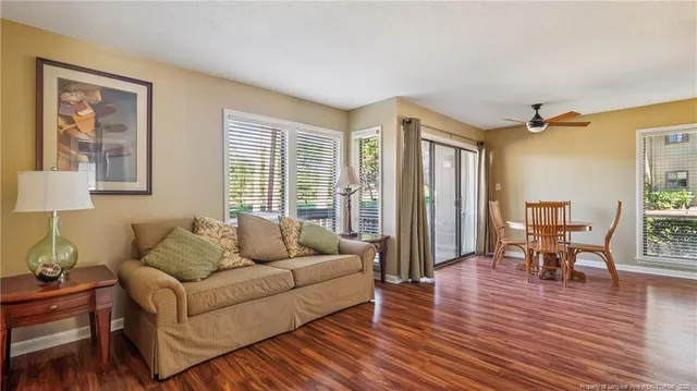 a living room with furniture and a wooden floor