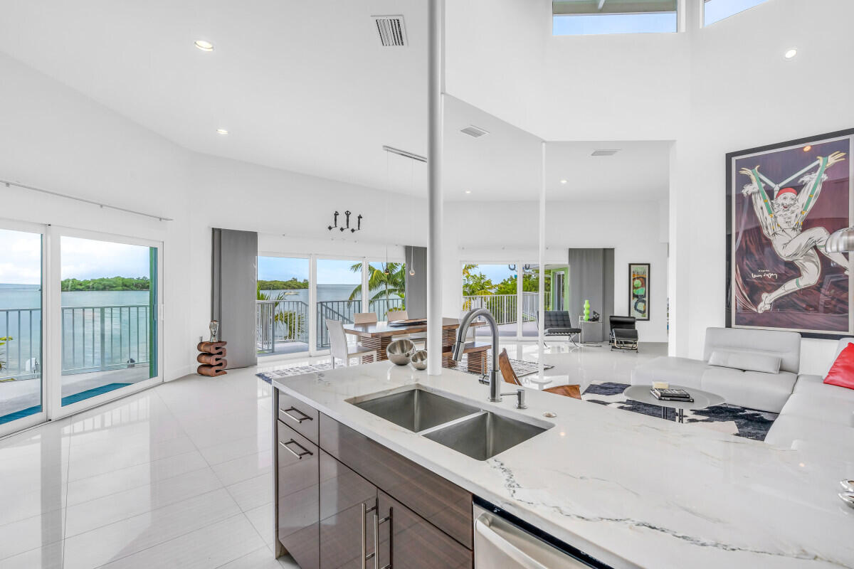 108 Sunset Drive Marathon, FL 33050 - Photo 13 of 46 a kitchen with sink refrigerator and large window