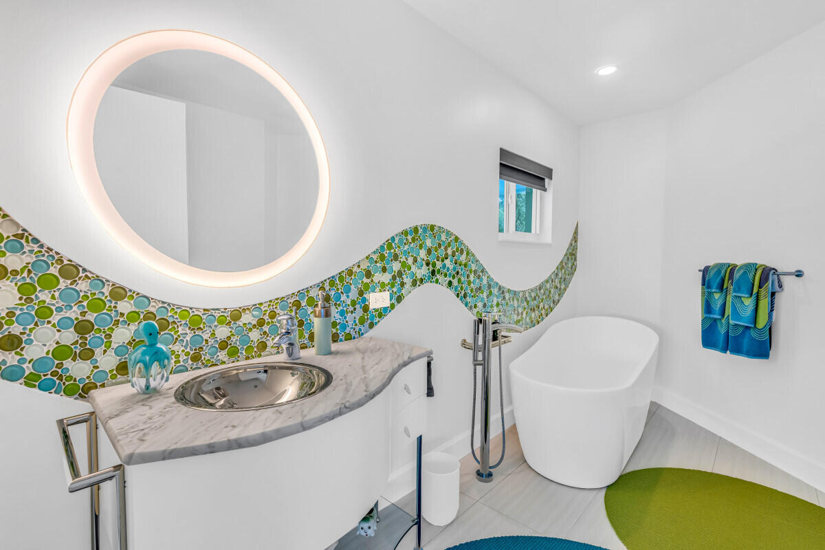 108 Sunset Drive Marathon, FL 33050 - Photo 24 of 46 a bathroom with a granite countertop sink and a mirror