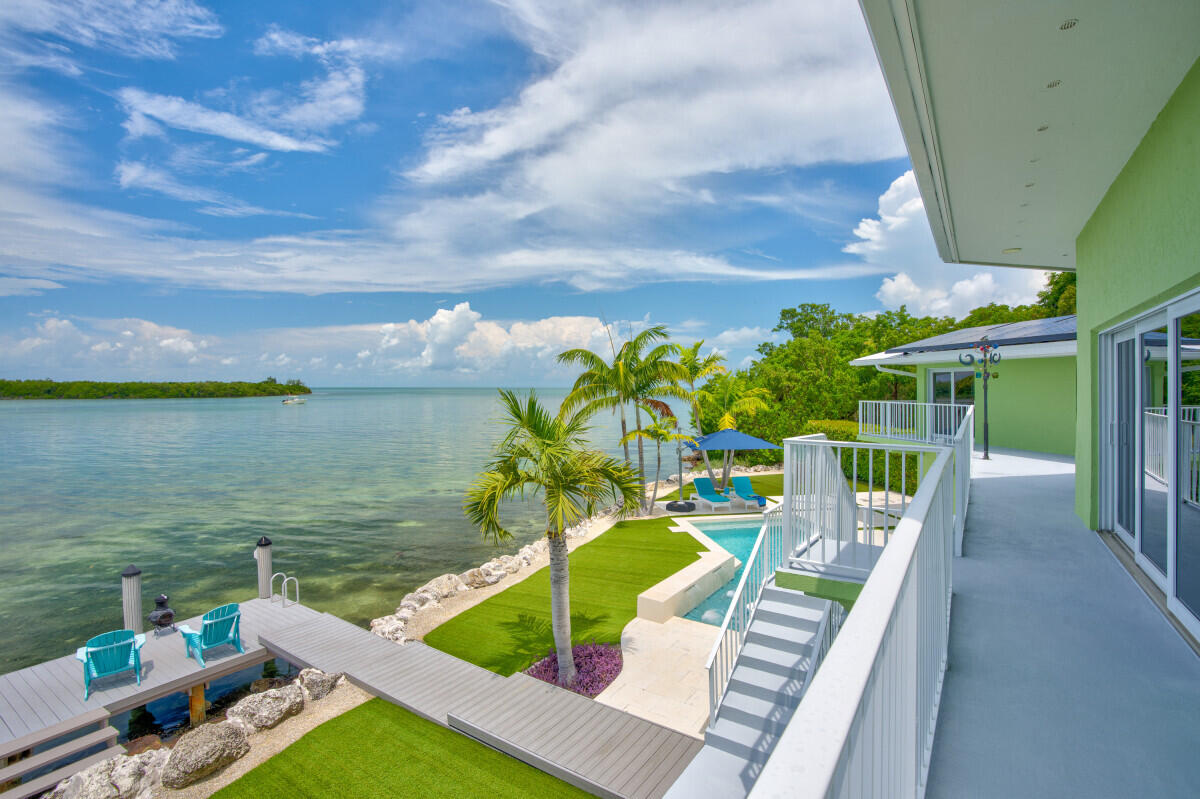 108 Sunset Drive Marathon, FL 33050 - Photo 28 of 46 a view of a chairs and table in patio