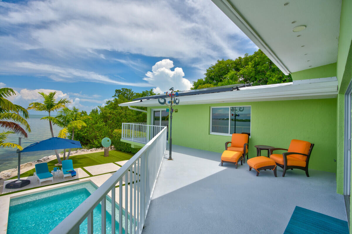 108 Sunset Drive Marathon, FL 33050 - Photo 29 of 46 a balcony with furniture and potted plants